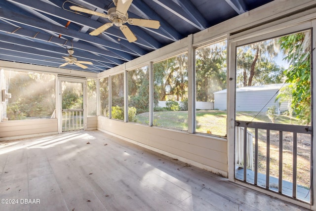 unfurnished sunroom with lofted ceiling with beams and ceiling fan