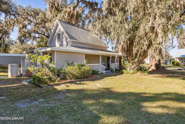 view of front of house with a porch and a front yard