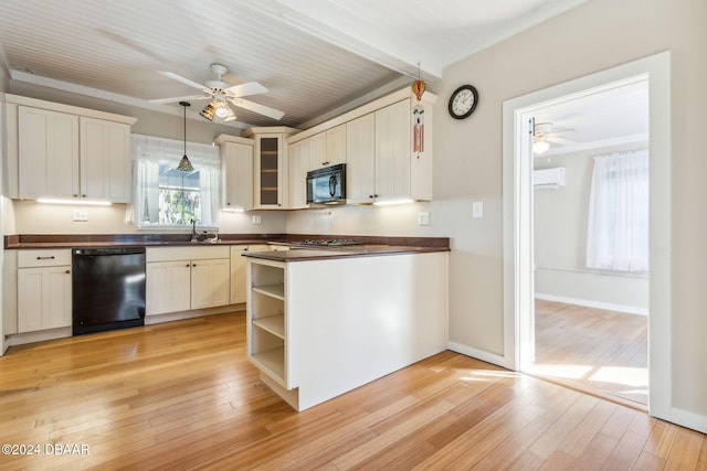 kitchen featuring sink, hanging light fixtures, black appliances, and light wood-type flooring