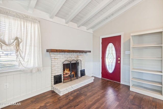 interior space with dark hardwood / wood-style floors, lofted ceiling with beams, wooden ceiling, and a brick fireplace