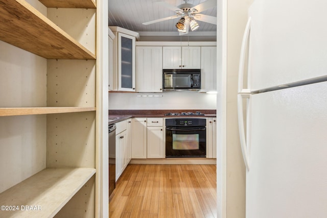 kitchen featuring white cabinetry, ceiling fan, black appliances, and light wood-type flooring