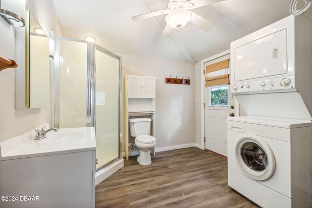 laundry area with ceiling fan, stacked washer and dryer, wood-type flooring, and sink