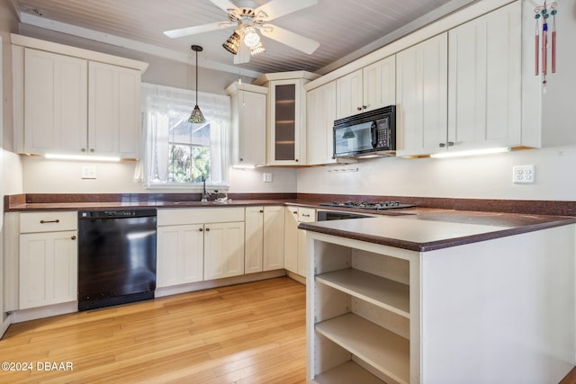 kitchen with sink, light hardwood / wood-style flooring, pendant lighting, white cabinets, and black appliances