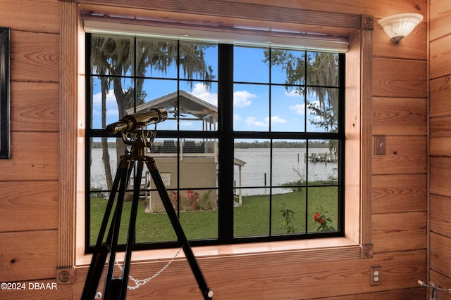 details featuring a water view and wooden walls