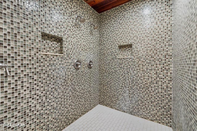 bathroom with tiled shower