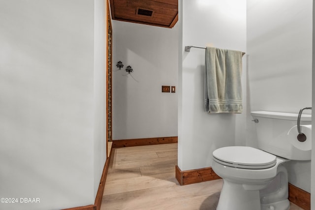 bathroom with wood-type flooring and toilet