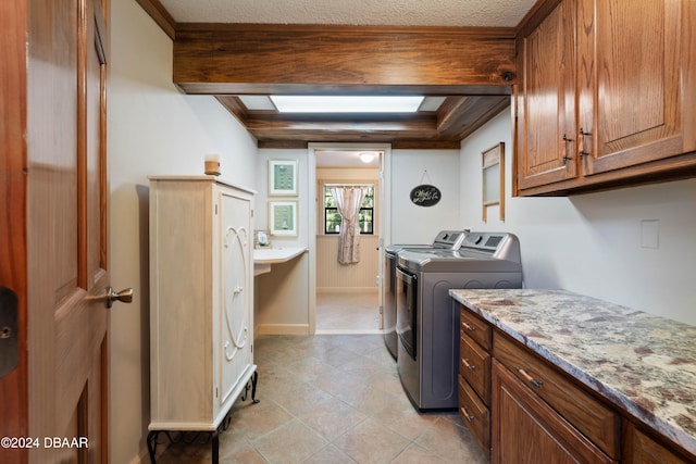 laundry area with washer and dryer and cabinets