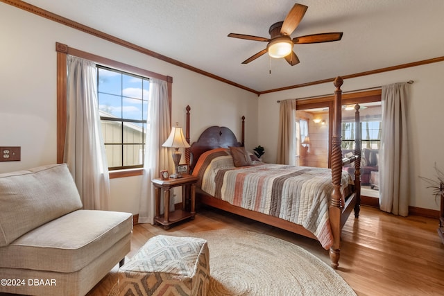 bedroom with a textured ceiling, light wood-type flooring, ceiling fan, and crown molding