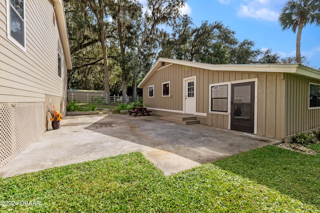 exterior space with a patio and a lawn