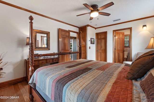 bedroom with hardwood / wood-style flooring, ceiling fan, a textured ceiling, and ensuite bath