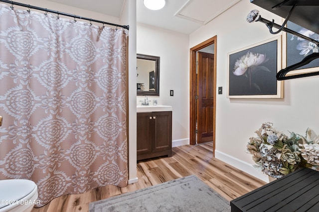 bathroom featuring wood-type flooring, vanity, and toilet