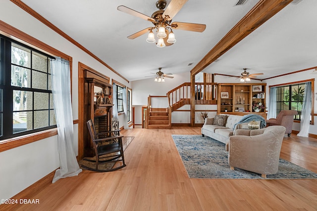 living room featuring vaulted ceiling with beams, light hardwood / wood-style floors, and ornamental molding