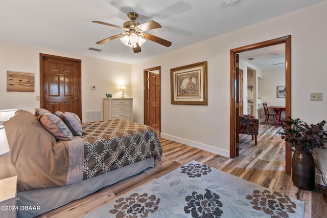 bedroom with ceiling fan and hardwood / wood-style flooring