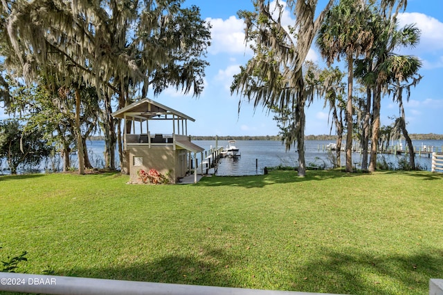 dock area with a yard and a water view