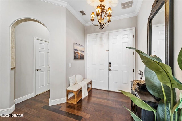 entrance foyer with dark hardwood / wood-style flooring, a notable chandelier, and crown molding