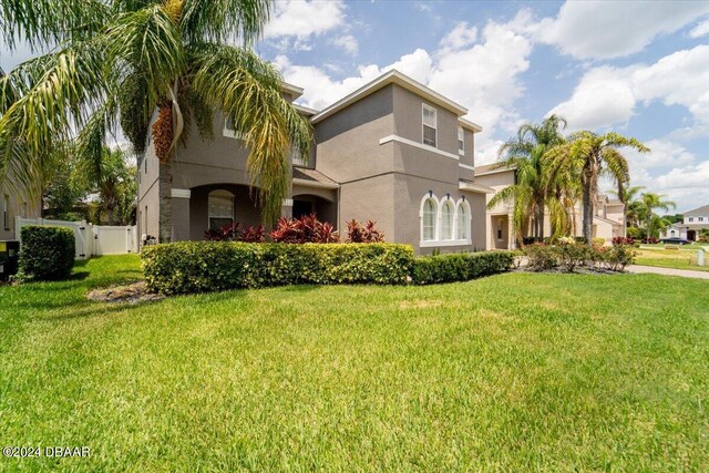 mediterranean / spanish house with a front yard