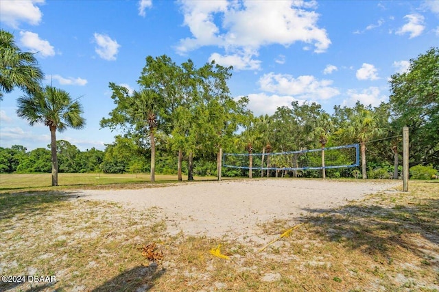 view of property's community with a yard and volleyball court