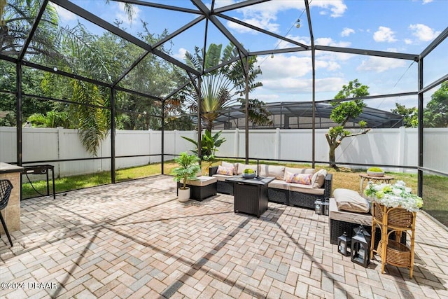 view of patio featuring outdoor lounge area and glass enclosure