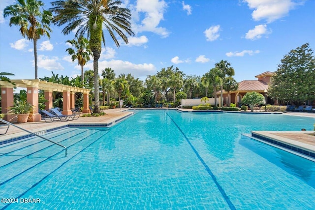 view of swimming pool with a patio and a pergola