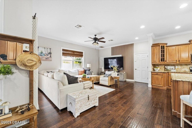 living room featuring ornamental molding, ceiling fan, and dark hardwood / wood-style floors