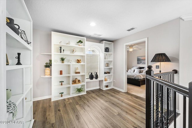 interior space featuring hardwood / wood-style flooring and a textured ceiling