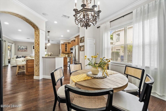 dining room featuring a chandelier, sink, dark hardwood / wood-style floors, and crown molding