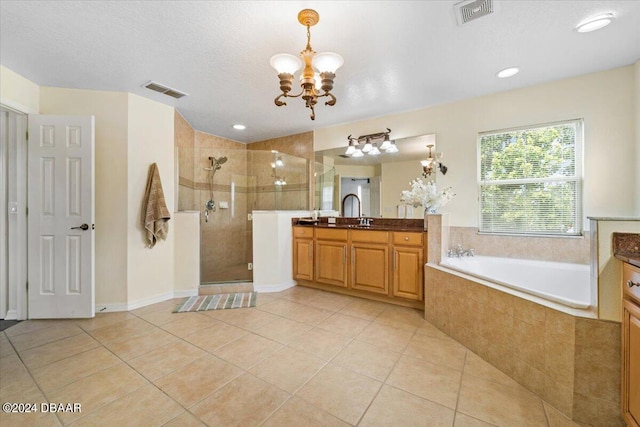 bathroom with vanity, an inviting chandelier, tile patterned flooring, and separate shower and tub