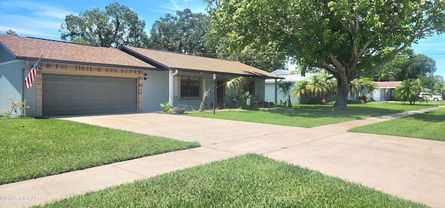 779 Aspen Dr, South Daytona, FL 32119 - single story home featuring a front lawn, driveway, an attached garage, and roof with shingles