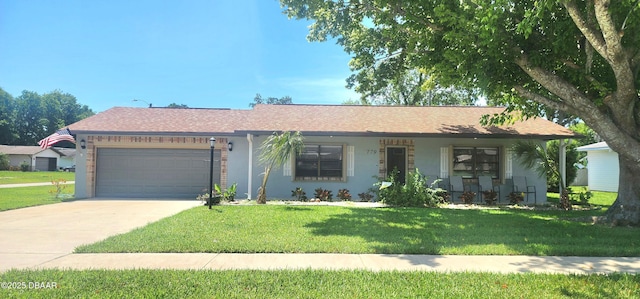 779 Aspen Dr, South Daytona, FL 32119 - single story home with an attached garage, a front lawn, concrete driveway, and covered porch