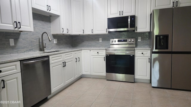 779 Aspen Dr, South Daytona, FL 32119 - kitchen with stainless steel appliances, a sink, decorative backsplash, and light tile patterned flooring