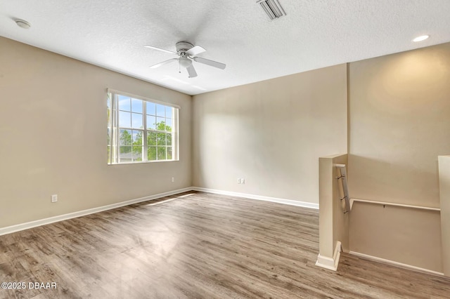253 Catriona Dr, Daytona Beach, FL 32124 - unfurnished room with baseboards, a textured ceiling, a ceiling fan, visible vents, and wood finished floors