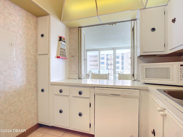 kitchen featuring white cabinets, white appliances, and light tile patterned floors