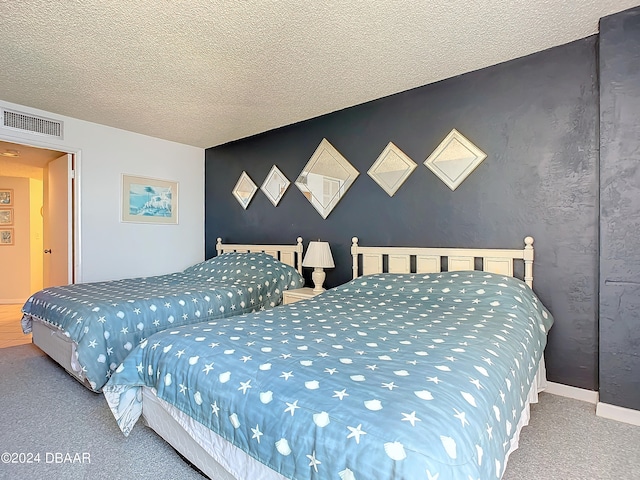 bedroom with carpet and a textured ceiling