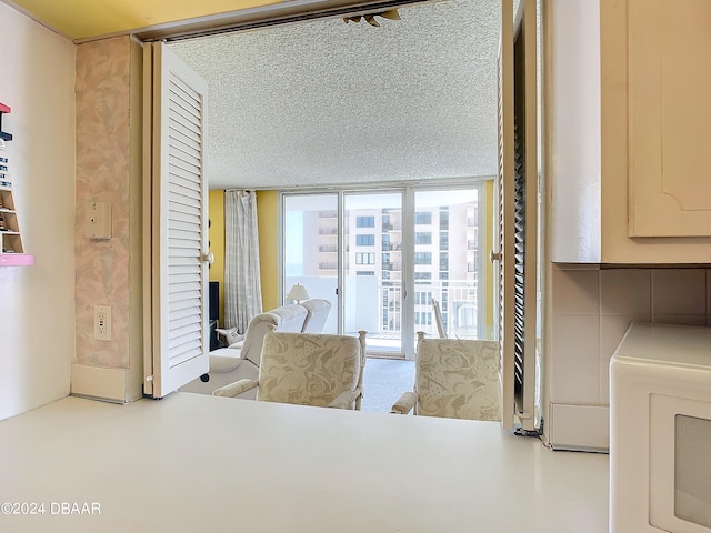 dining space featuring a textured ceiling and floor to ceiling windows