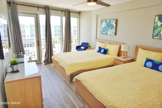 bedroom featuring ceiling fan, light wood finished floors, and access to outside