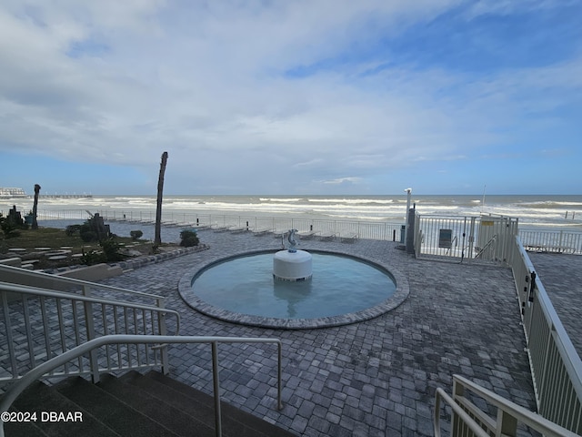exterior space featuring a view of the beach and a water view