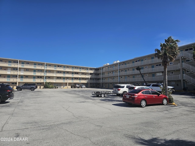 view of property featuring uncovered parking