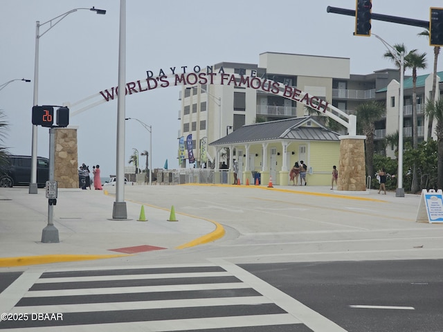 219 S Atlantic Ave Unit 428, Daytona Beach, FL 32118 - view of asphalt road featuring traffic lights, street lighting, traffic signs, sidewalks, and curbs