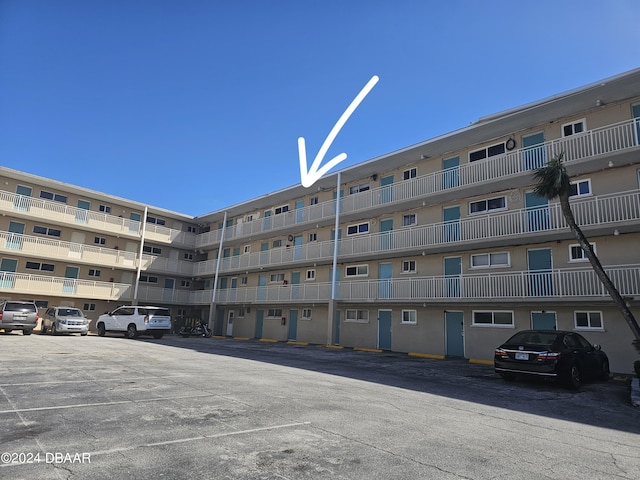 view of building exterior featuring uncovered parking