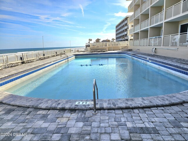 pool featuring fence and a water view