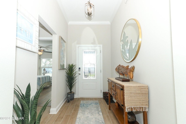 foyer with light hardwood / wood-style floors, ceiling fan, and crown molding