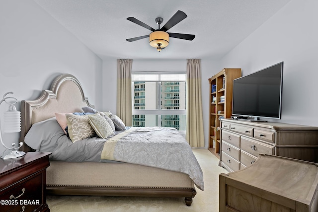 bedroom featuring light colored carpet and ceiling fan