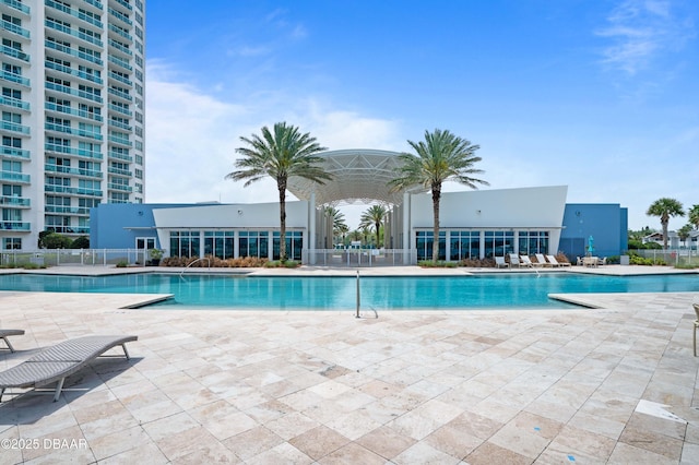 pool featuring a patio area and fence
