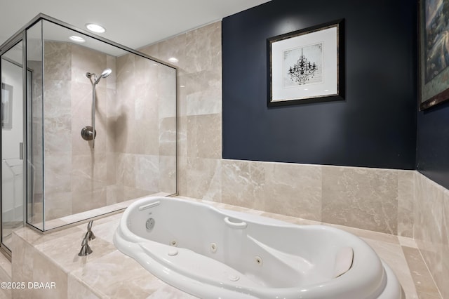 bathroom featuring a shower stall and a jetted tub
