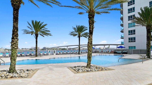 pool featuring a patio area and fence