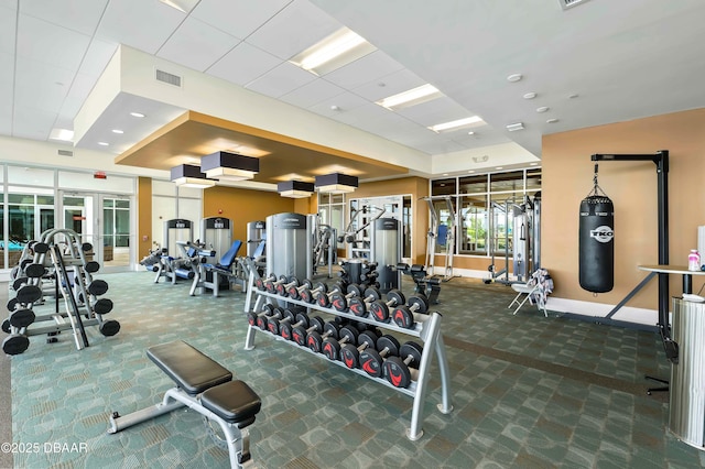gym featuring visible vents, baseboards, carpet flooring, and a paneled ceiling