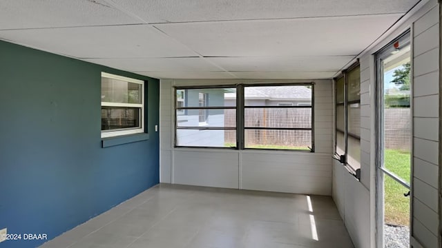 unfurnished sunroom with a paneled ceiling