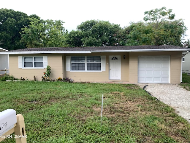 ranch-style house with a garage and a front yard