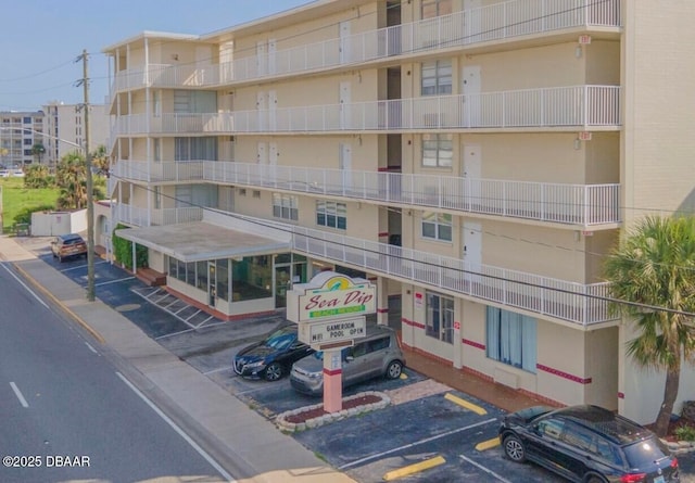 view of building exterior featuring uncovered parking