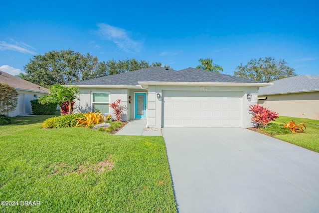 ranch-style house with a garage and a front yard